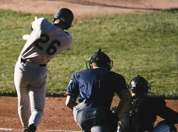 Brandon Harper (left) of the Kane County Cougars swings at a pitch against the Michigan Battle Cats during a 1998 game in Battle Creek, Michigan.