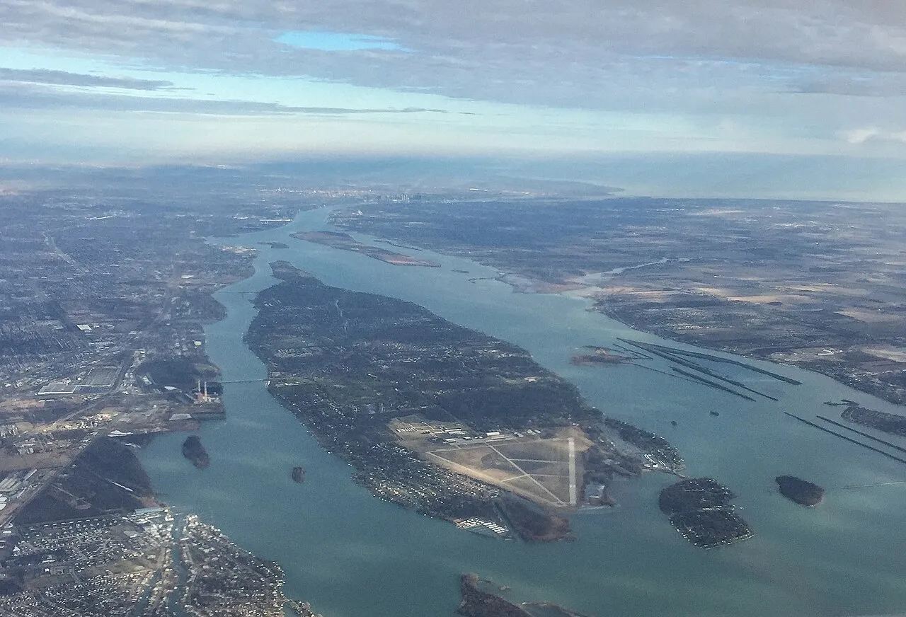 Aerial view of Grosse Ile in the Detroit River from the south, as viewed from an aircraft shortly after takeoff from Detroit Metropolitan Wayne County Airport. Grosse Ile Municipal Airport can be seen at the southern end