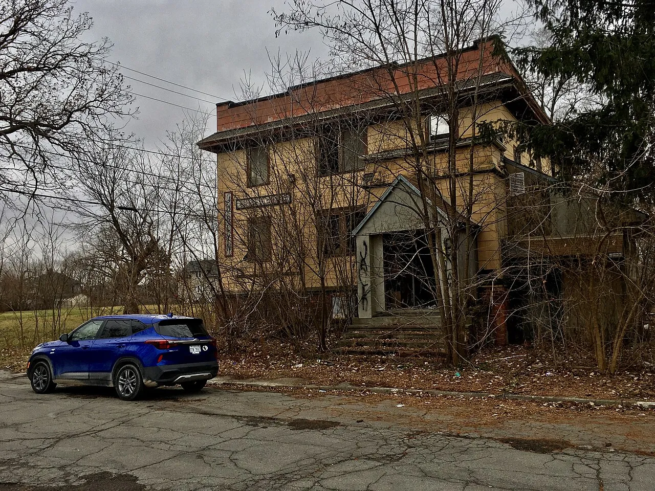 Encroaching blight and urban prairie characterizes the northwest quadrant of Highland Park, Michigan, as seen in this December 2020 scene at the corner of Joslyn Avenue and Florence Street. The building seen here was ere