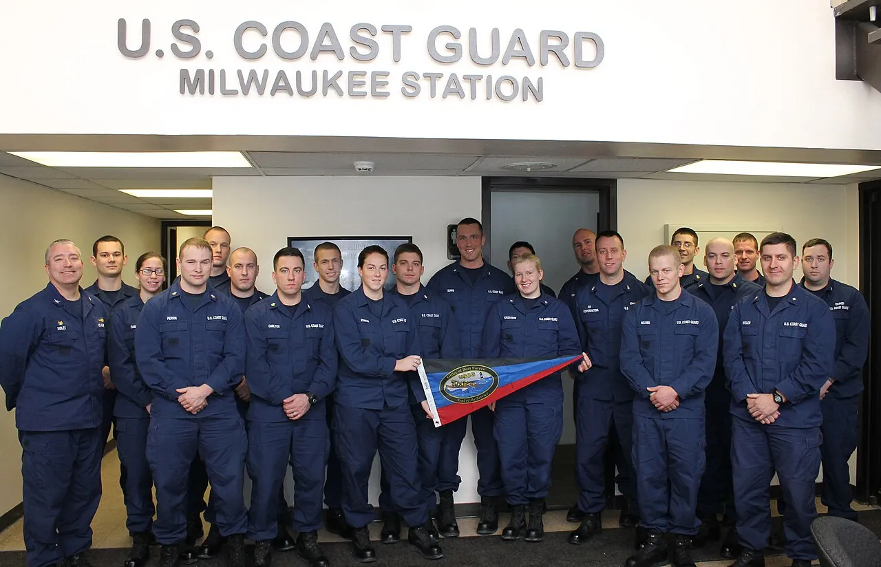 Capt. Matthew Sibley, commander of Coast Guard Sector Lake Michigan, poses with crew members from Coast Guard Station Milwaukee after presenting the unit with the Sumner I. Kimball Award for Excellence, Jan. 31, 2014. Th
