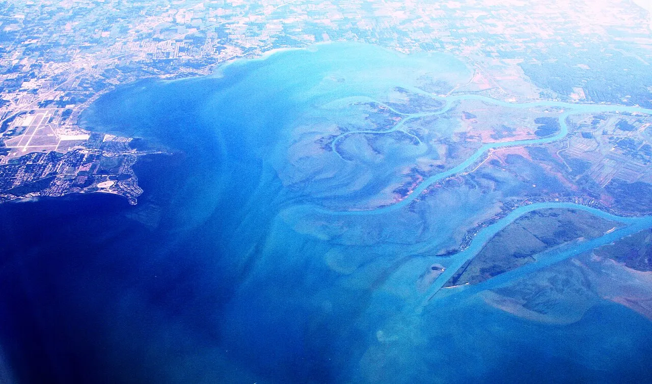 Aerial view from the south towards north, over Macomb County, southeastern Michigan. This county surrounds Detroit city in the north and northeast of the metropolitan area. The Anchor Bay is a part of Lake St Clair, by t