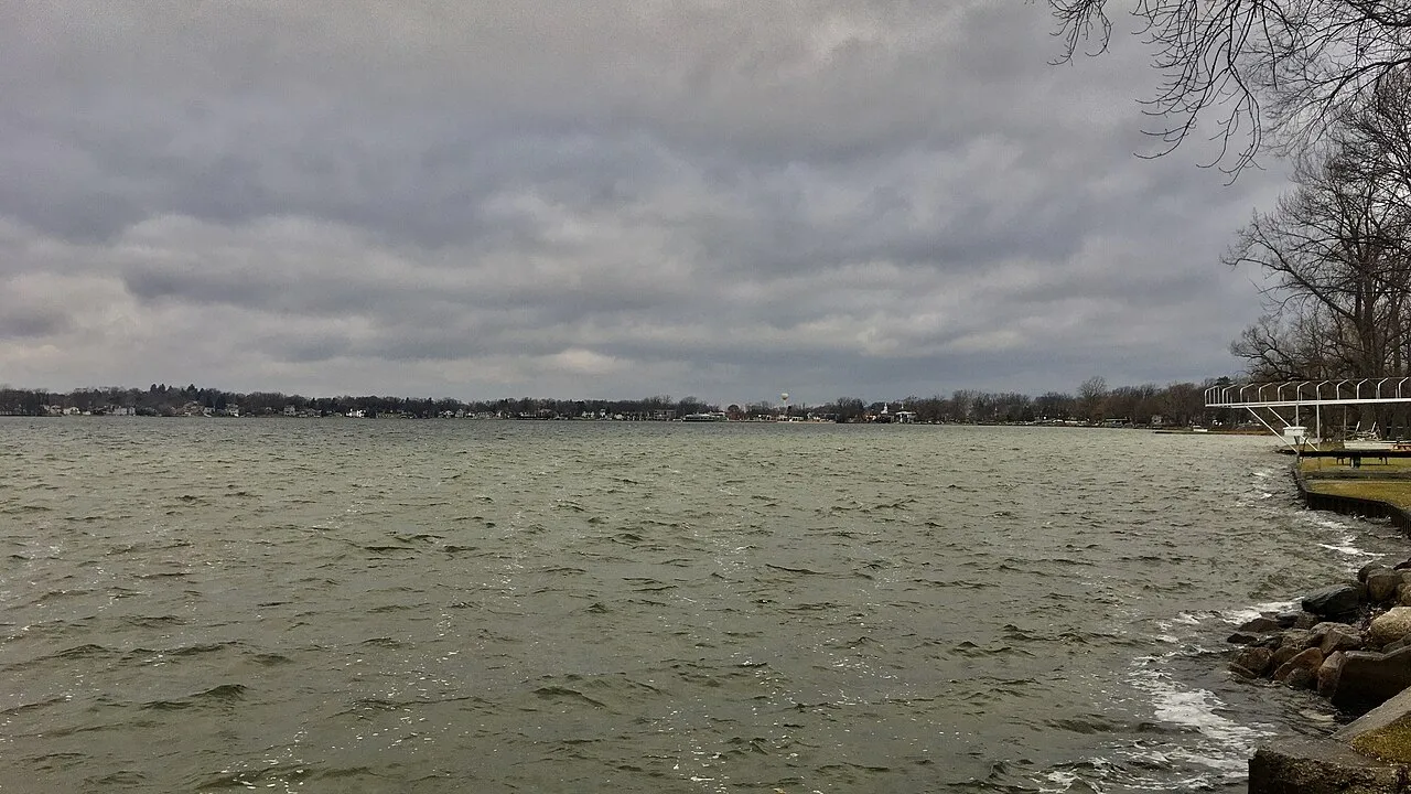 Looking northwestward across Walled Lake from East Lake Drive a short distance south of West 14 Mile Road, on the premises of the Beachwalk Apartments in Novi, Michigan, December 2020. The waterfront district of the City