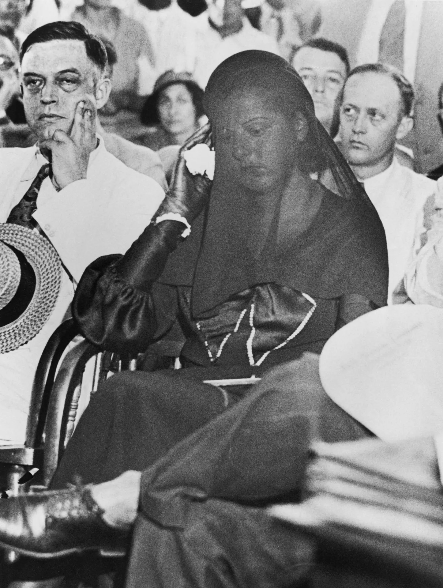 Libby Holman at the bond hearing at the Wentworth, NC courthouse, wearing a veil and black mourning. She was accompanied by her father, lawyer Alfred