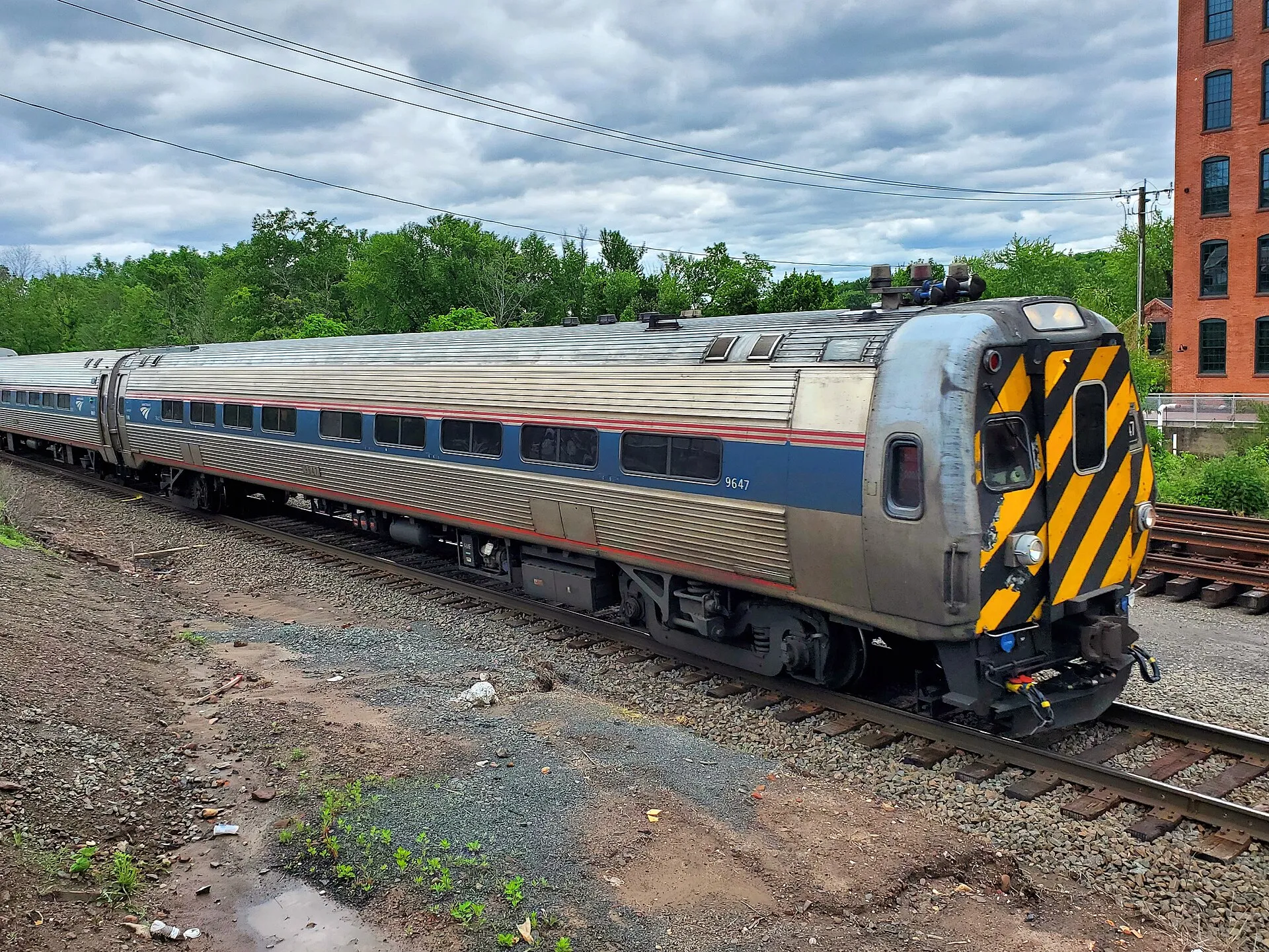 Southbound Amtrak Hartford Line train passing through downtown Windsor Locks, June 2025.