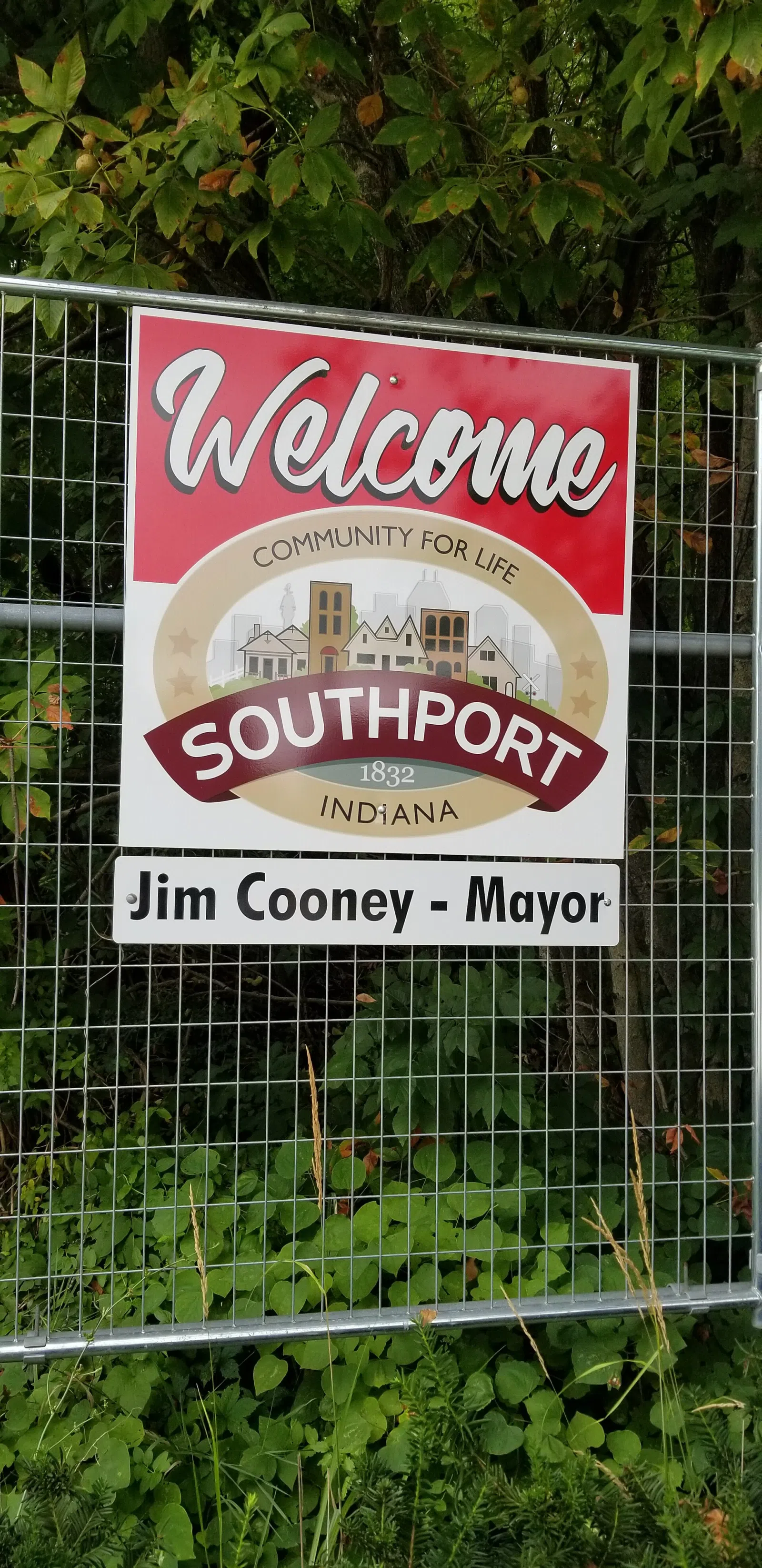 A sign welcoming visitors to Southport, Indiana and providing information about the mayor.