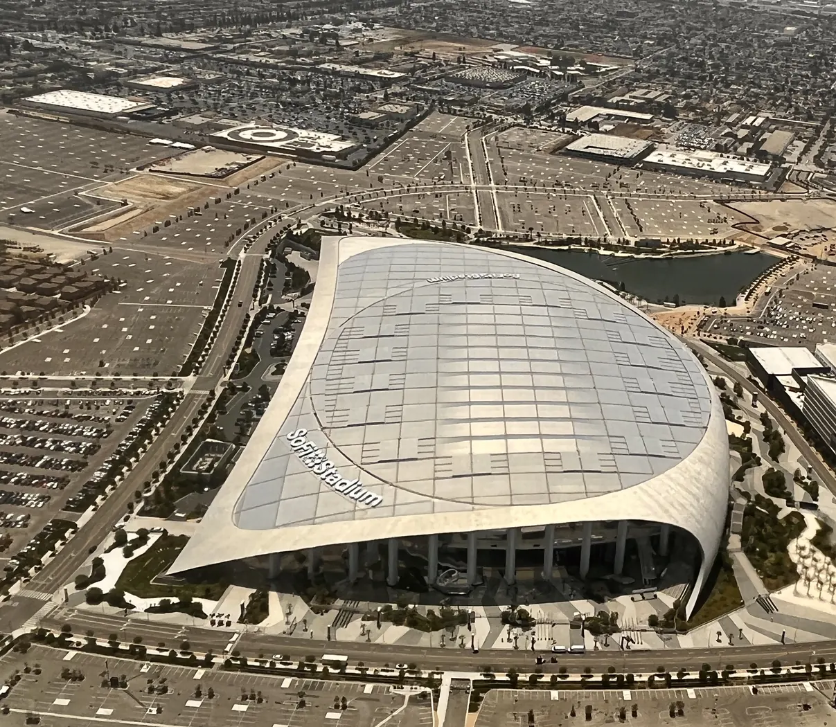 Aerial view of SoFi Stadium's translucent roof and the Hollywood Park development, July 2022