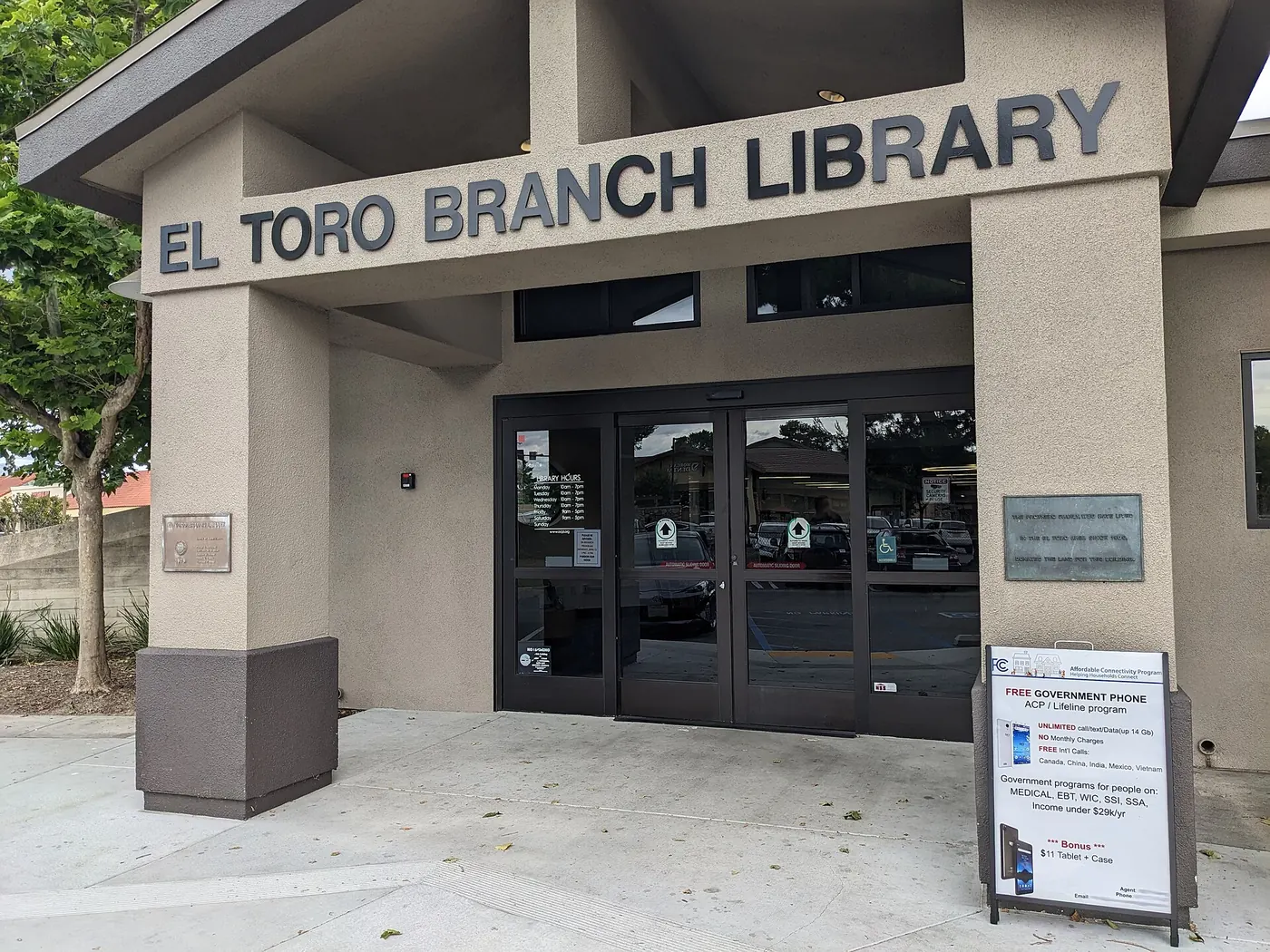 The front entrance of the El Toro Branch Library, a public library with the Orange County Public Library system in Lake Forest, Orange County, California. Legible information includes the name of the.