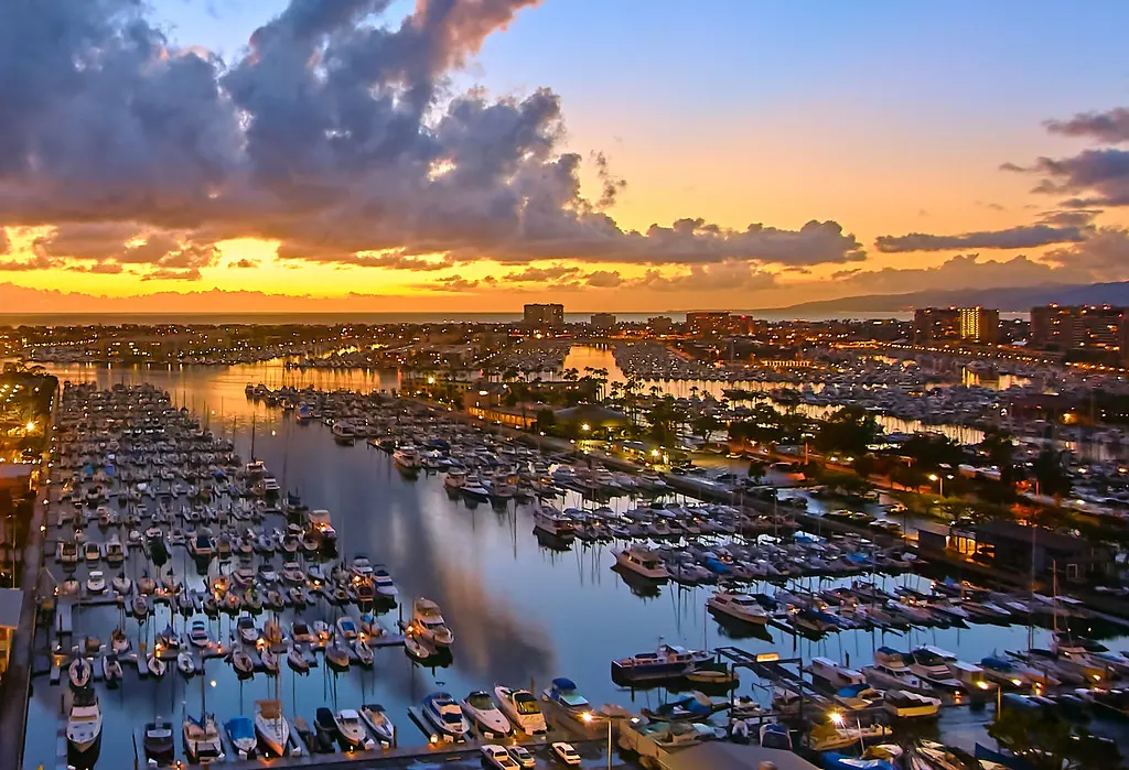 Boats moored in the Marina del Rey harbor at dusk.