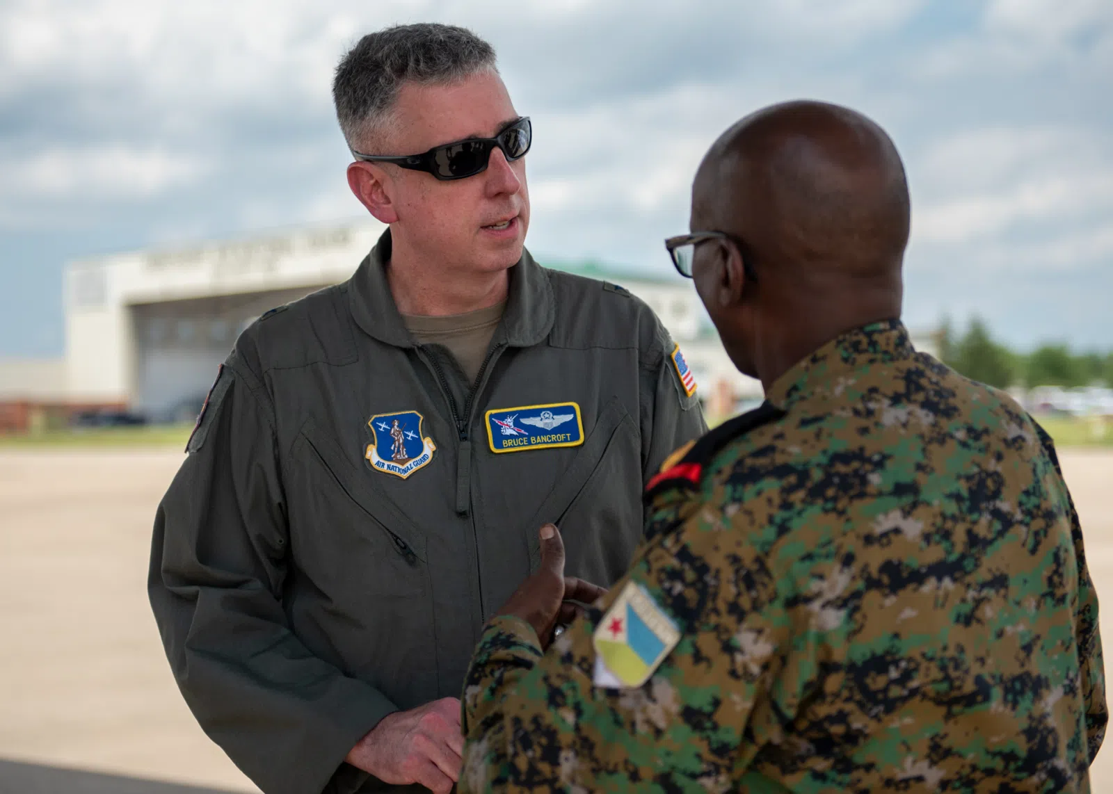 U.S. Air Force Brig. Gen. Bruce Bancroft, Kentucky’s assistant adjutant general for Air, speaks with Col. Ali Aden of the Djiboutian Army during a tour of the Kentucky Air National Guard Base in Louisville, Ky., July 22, 2025. The visit was part of a multi-day information exchange with the Kentucky