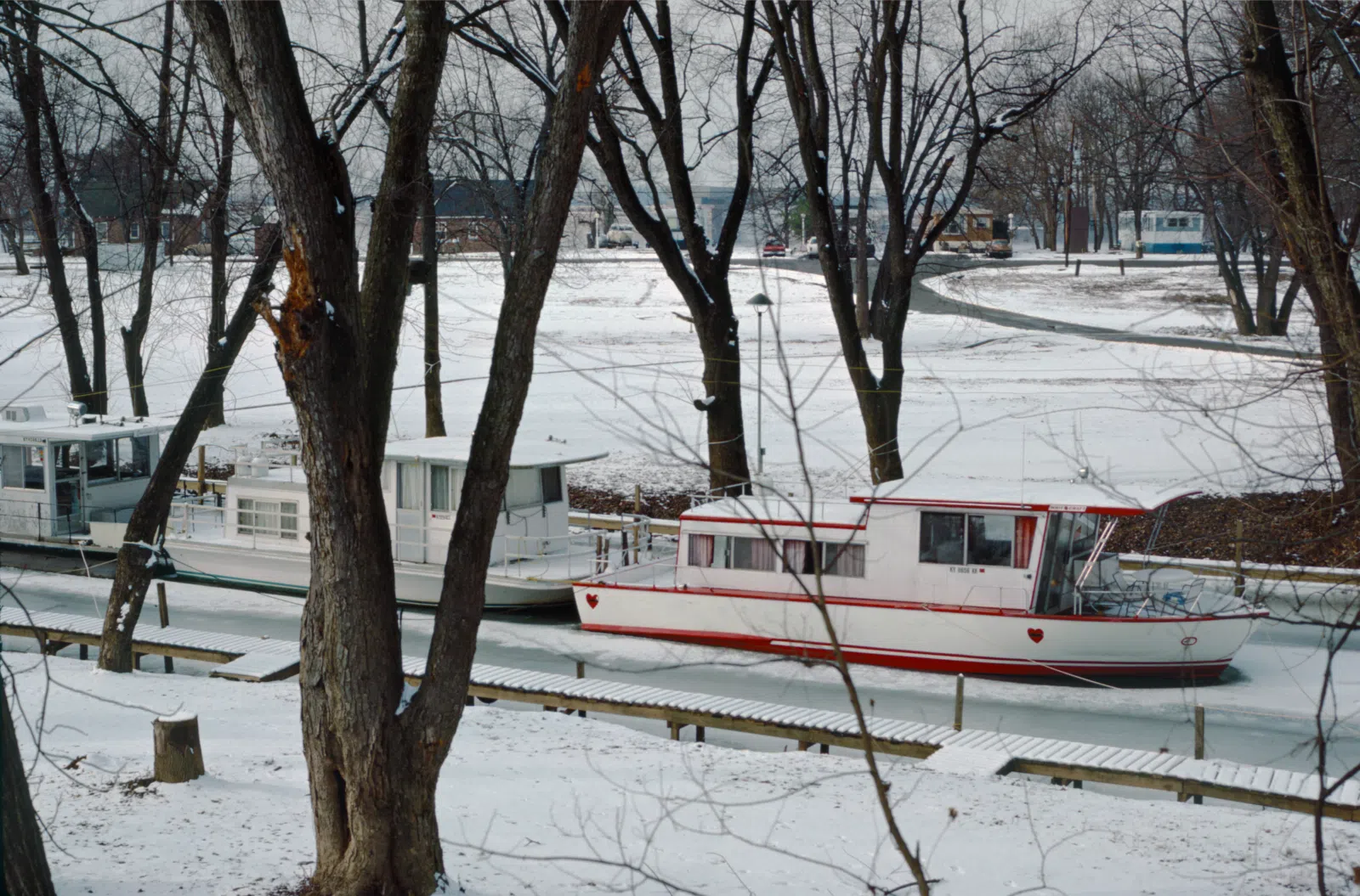 Looking NW from left bank of Goose Creek near Eifler Beach. Houseboat "Queen of Hearts" and others moored mid-creek for the winter. Ohio River mile 597. Louisville, Kentucky. January 1988. File # 88a038. . 35 mm Kodachrome. Plustek OpticFilm 7600i and Silverfast 8. Picture Window 6. JPEG quality 95.