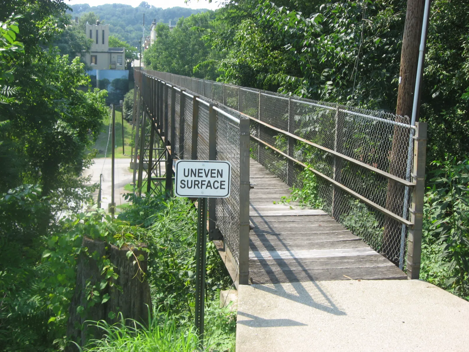 Eastern end of the Goose Creek Foot Bridge, which connects Court and Depot Streets in Greensburg, Kentucky, United States. Built in 1928, it is listed on the National Register of Historic Places.