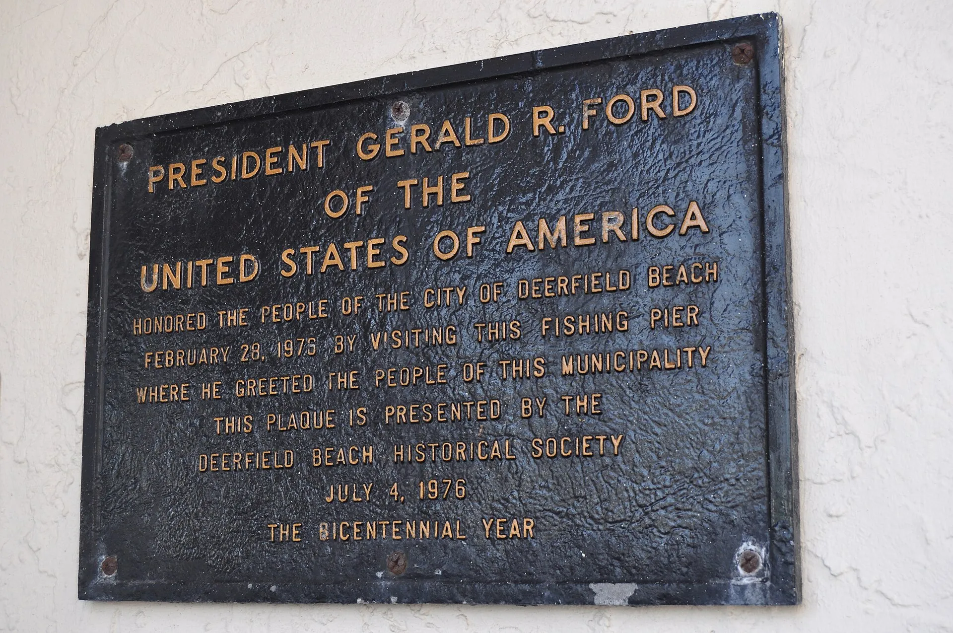 Historical plaque at the entrance to the Deerfield Beach, Florida fishing pier.