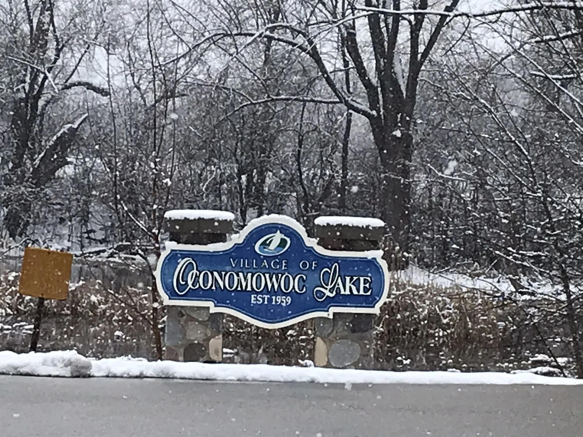 Welcome sign for the village of Oconomowoc Lake, Wisconsin.