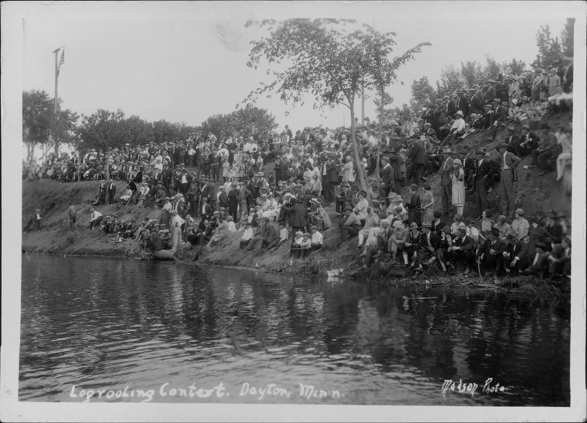 The audience watching a the contest from the banks of the Mississippi River. The contest marks the opening of a new ferry boat service in Dayton, MN..