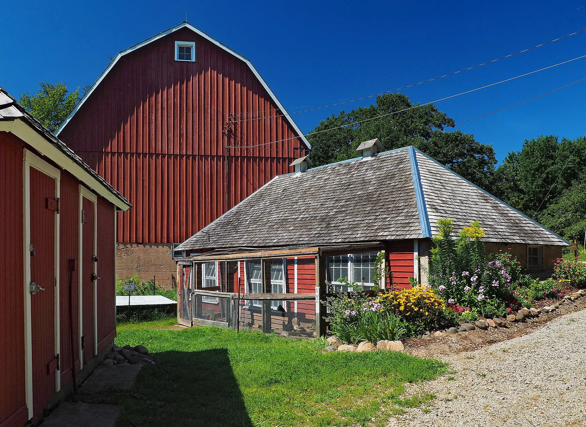 Holz Farm, 4665 Manor Dr, Eagan, Minnesota, USA. Contributing properties left to right are the milk & pump house, stock tank, barn, and chicken coop, viewed from the east.