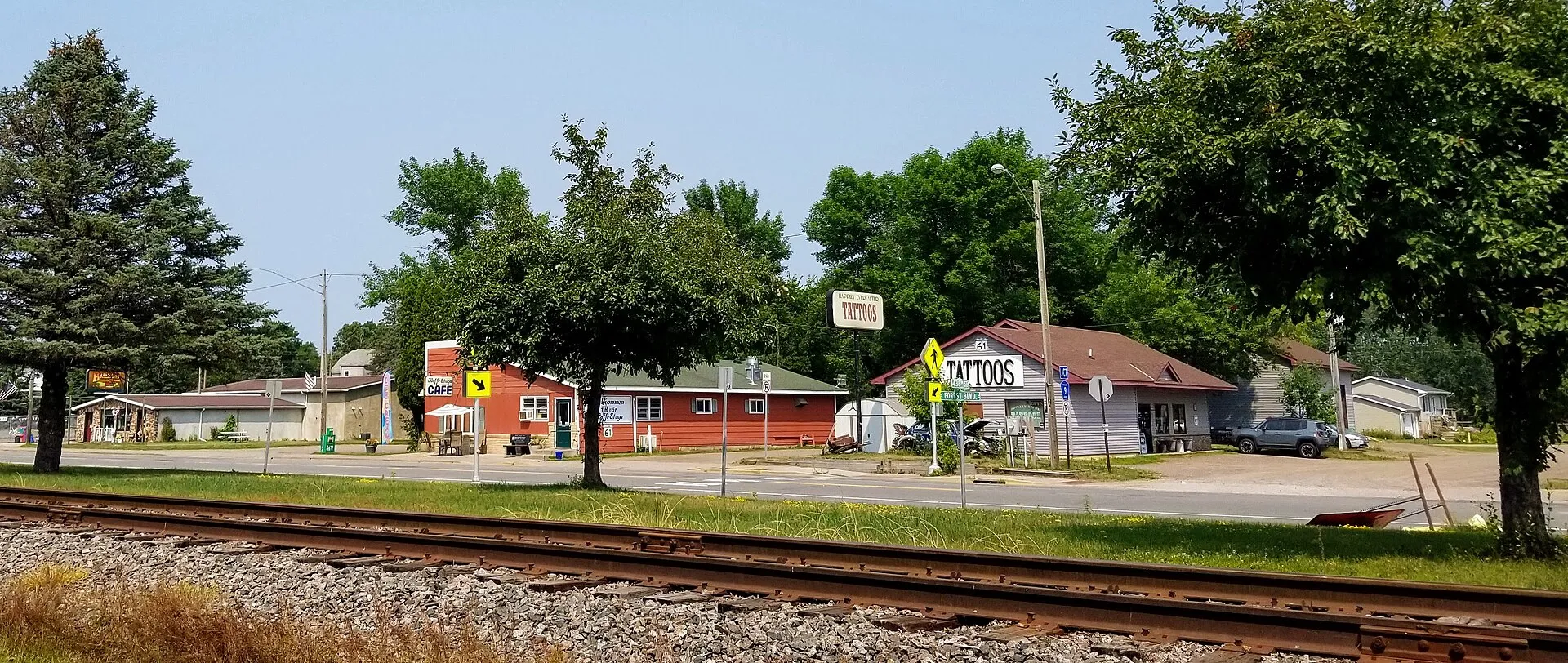 Businesses along the main street of Harris, Minnesota, Forest Boulevard. Businesses shown include the Kaffe Stuga cafe and Happily Ever After tattoo shop