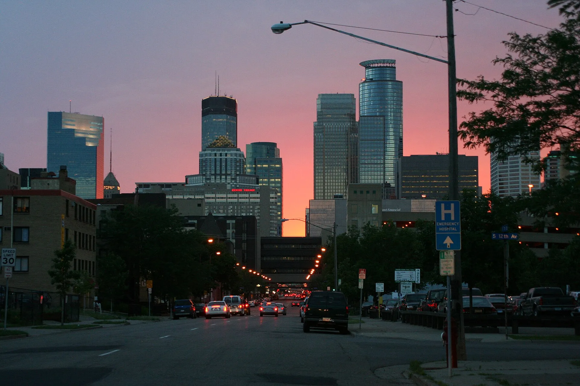 Skyline of Minneapolis, Minnesota with bright sunset behind..
