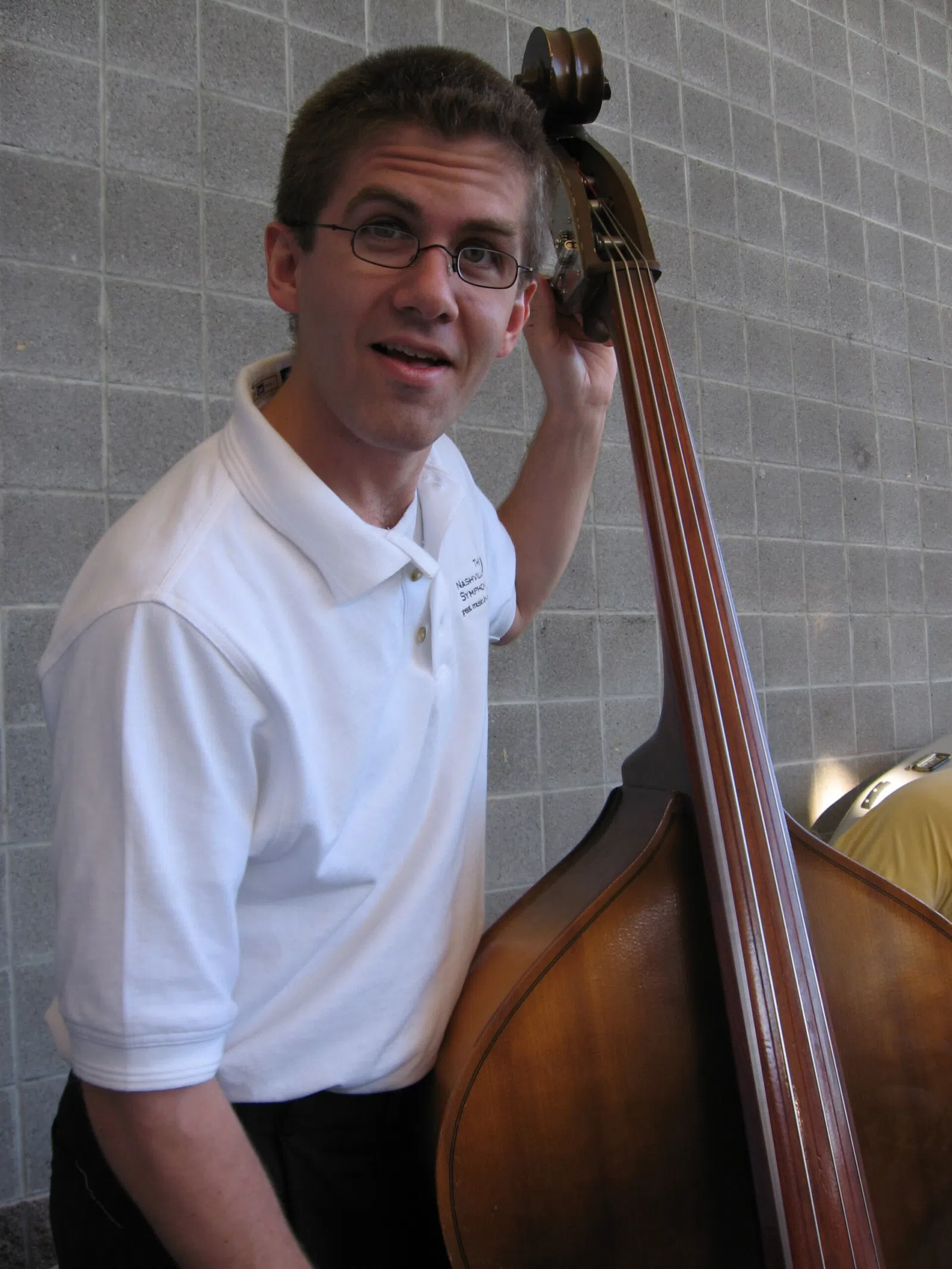 Ryan Kamm, bass, tuning the mighty Kay bass (one of a complete set - every bass player was playing on a Kay this evening). This picture is part of a set from a concert by the Nashville Symphony at Brentwood's Crockett Park , May 13. 2007.