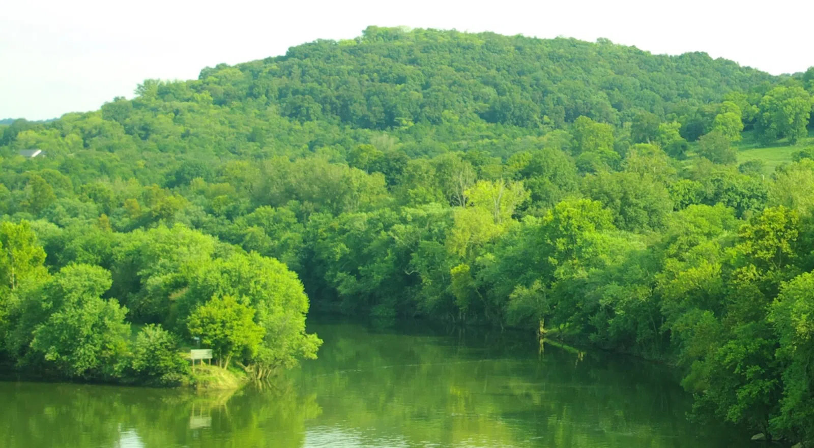 The mouth of the Caney Fork along the Cumberland River in Carthage, Tennessee , United States. The Caney Fork is to the right of the white sign, while the Cumberland is visible in the lower left-hand corner of the photo. This view is from the Highway 25 (Gordonsville Highway) bridge over the C