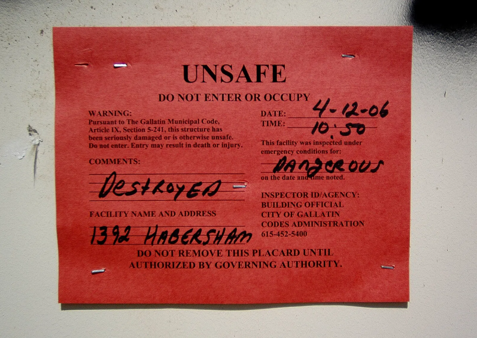 Gallatin, TN -- April 15, 2006 -- A close up of a "red tag" on a destroyed house in downtown Gallatin. Middle Tennessee was recently hit by a series of tornadoes that damaged homes and office buildings. Leif Skoogfors/FEMA