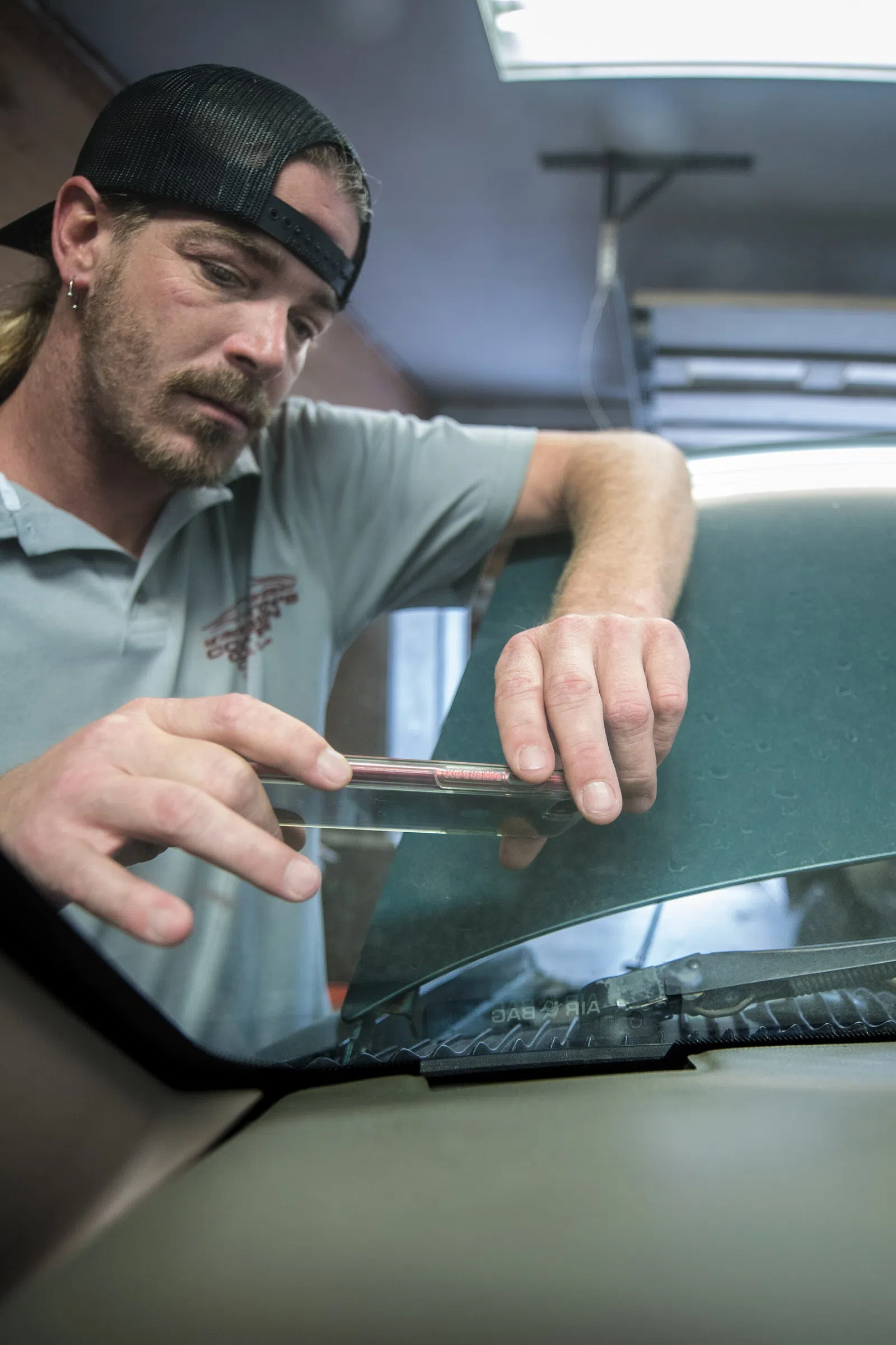 Covingtonâs Collision Center co-owner Rocky Covington photographs a vehicle idnetification number on a customer's car at his family business, in Westmoreland, TN, where sending high resolution photos is quick and easy with the a high-speed fiber-optic connection to North Central Telephone Cooperativ
