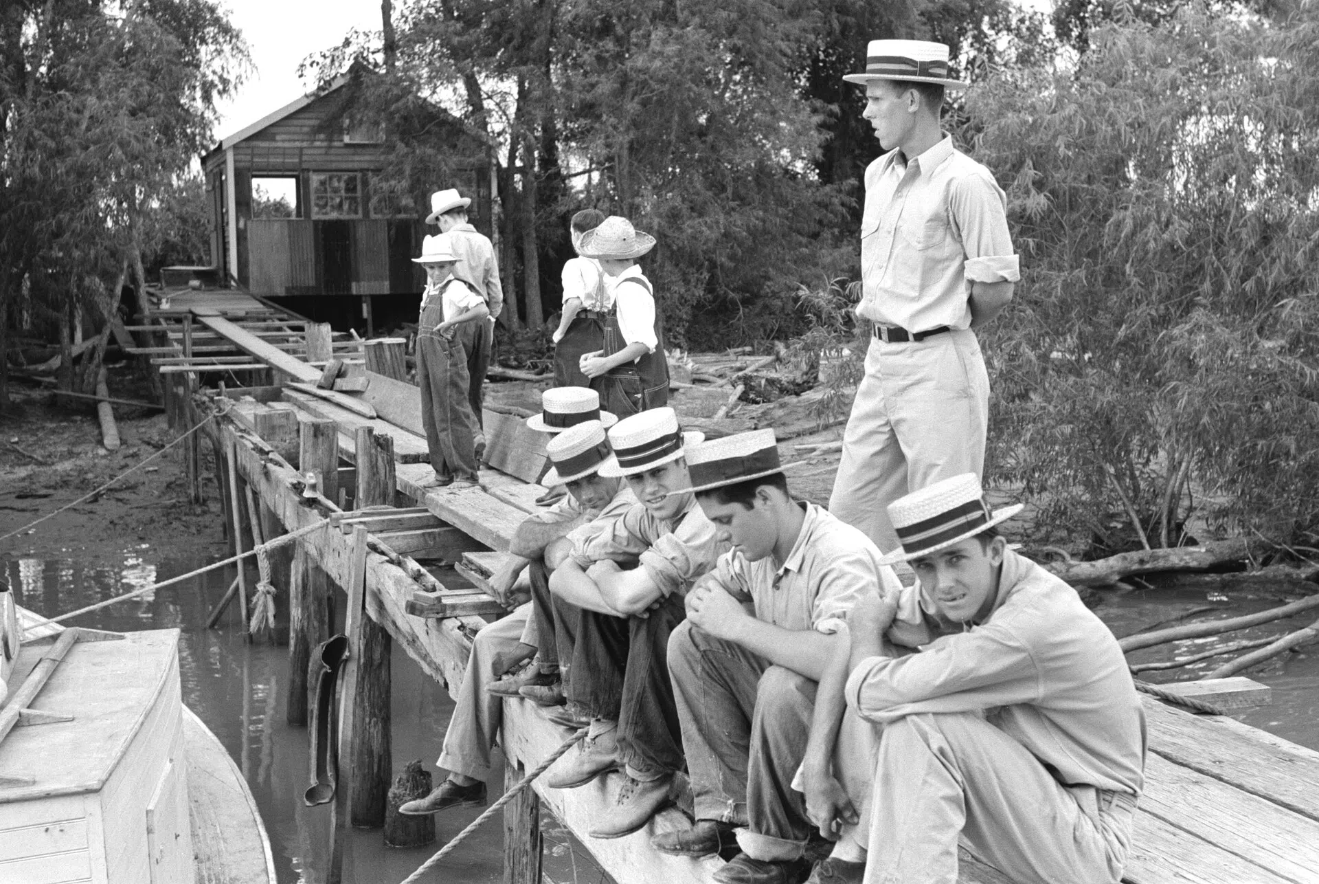 Residents of Boothville, Louisiana, sitting on a dock, 1938 (Farm Security Administration)