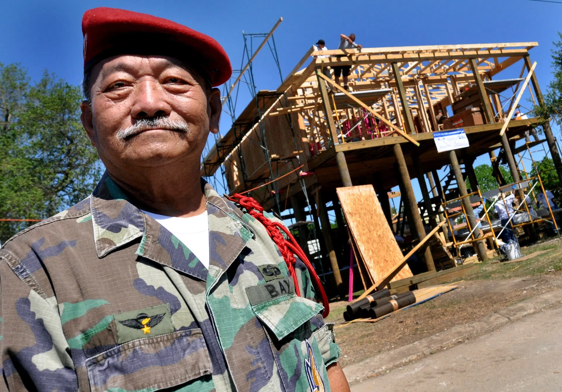 Buras, Louisiana, April 2011 — a local sailor watches his home being rebuilt by volunteers after Hurricane Katrina
