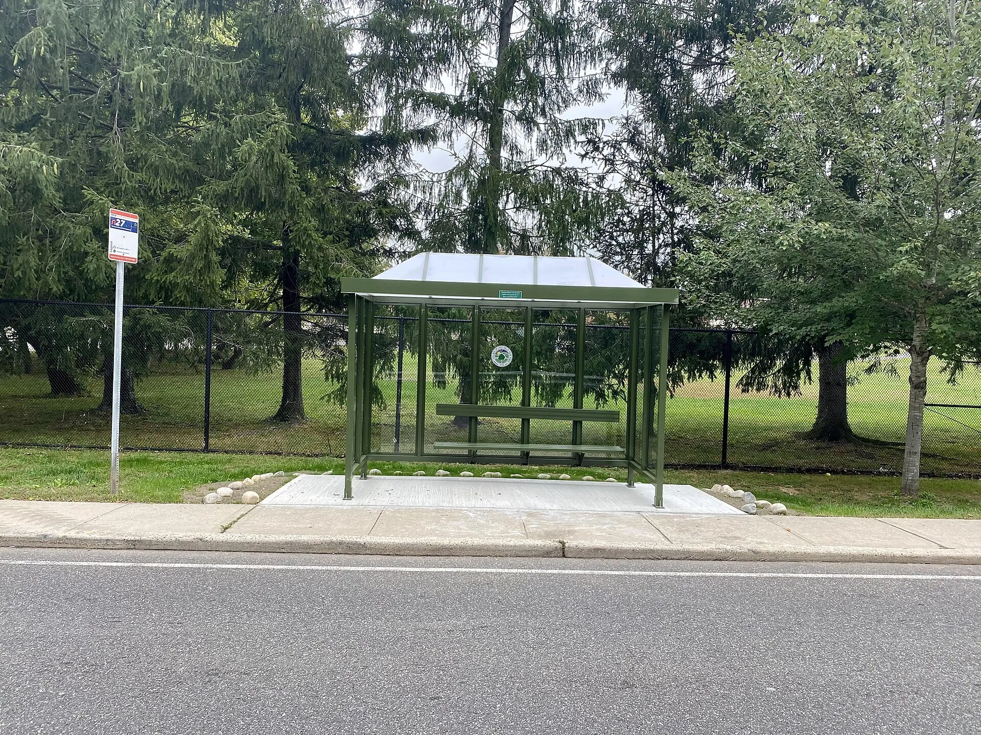 A Nassau Inter-County Express (NICE) bus stop on Harbor Hill Road in East Hills, Long Island, New York on October 13, 2021, located in front of the Park at East Hills, which contains Village Hall