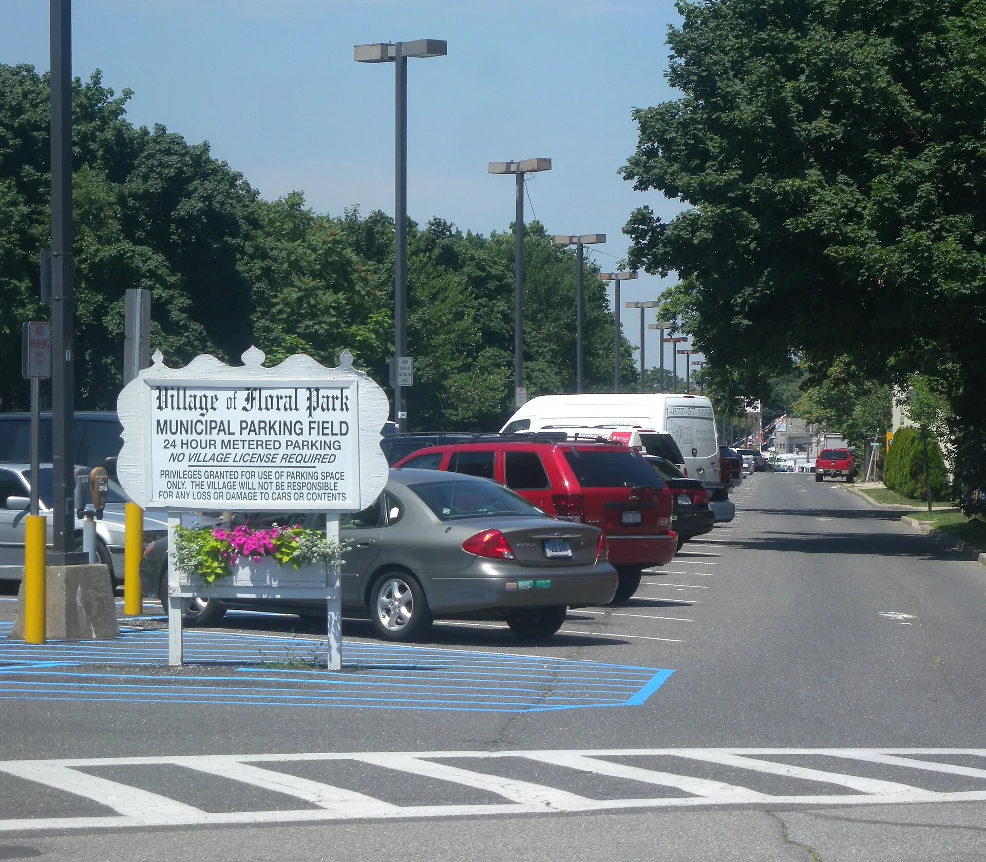 Looking northwest along Floral Park Municipal Parking Field, formerly the Stewart Line, on a sunny midday