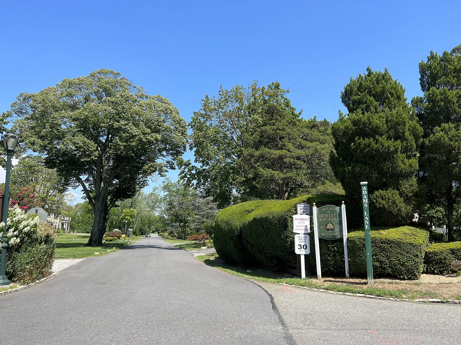 Adams Lane in the Inc. Villages of Hewlett Bay Park & Hewlett Neck, NY on August 8, 2022, as seen from Ocean Avenue. The boundary between the two villages runs along the centerline of Adams Avenue