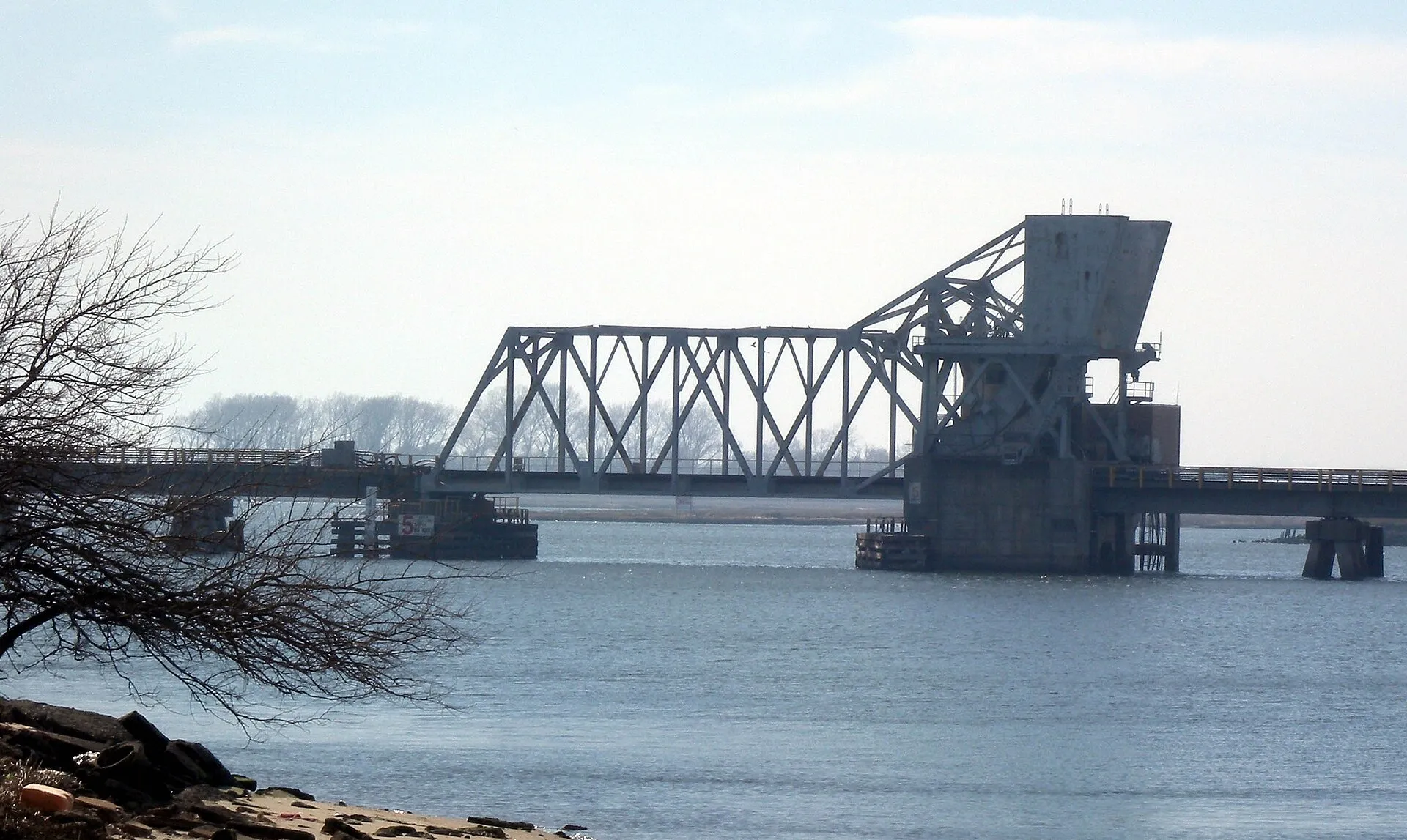 Looking west along south shore of Reynolds Channel at the drawbridge of Long Beach Line on a partly sunny afternoon