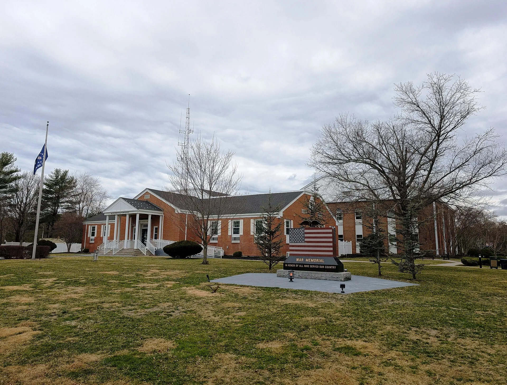 Photo of the Manchester Township, New Jersey municipal building and war memorial. Photo taken from Colonial Drive looking west