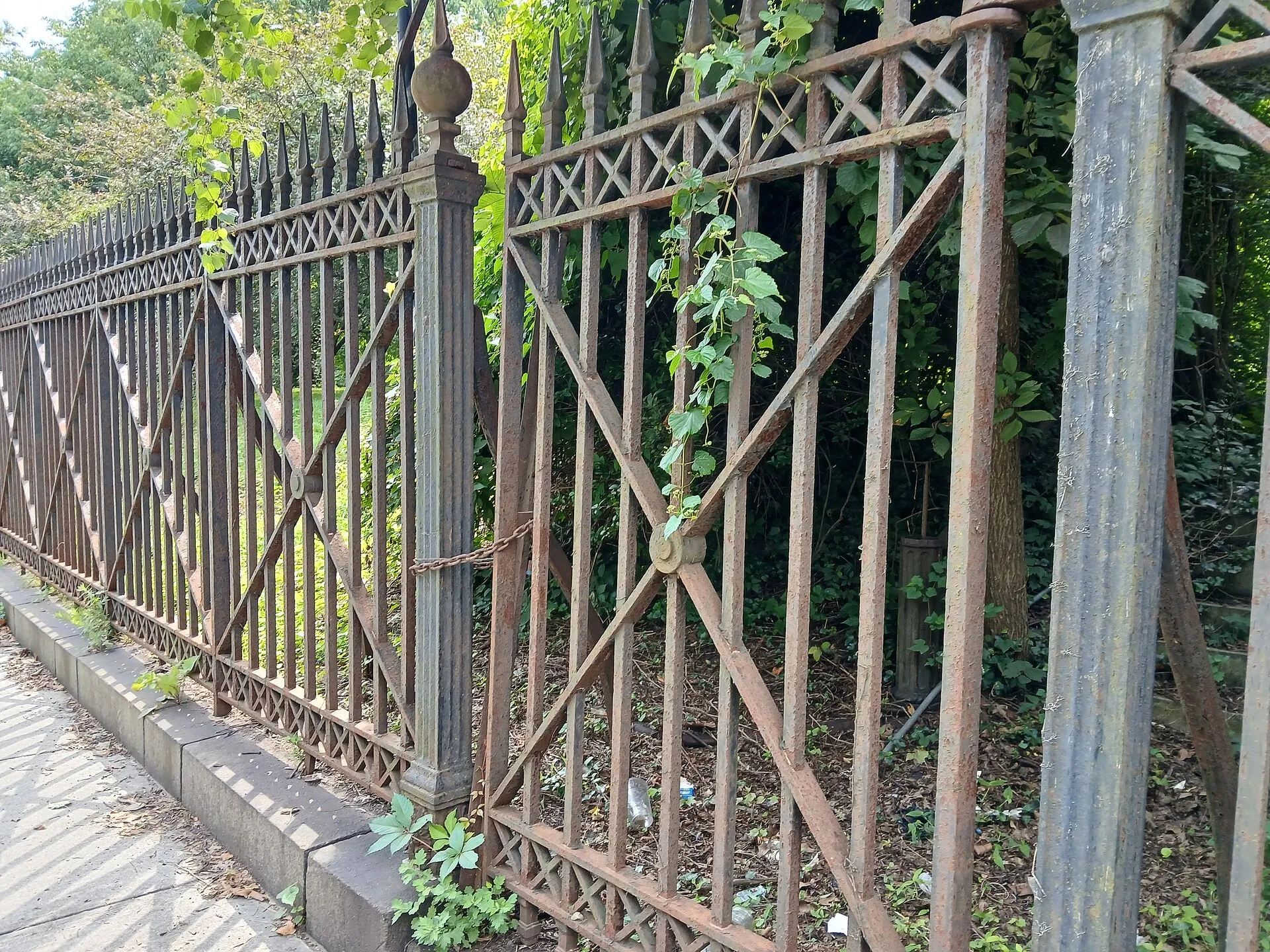 The city-landmarked north fence at Snug Harbor, Staten Island, New York, August 2026