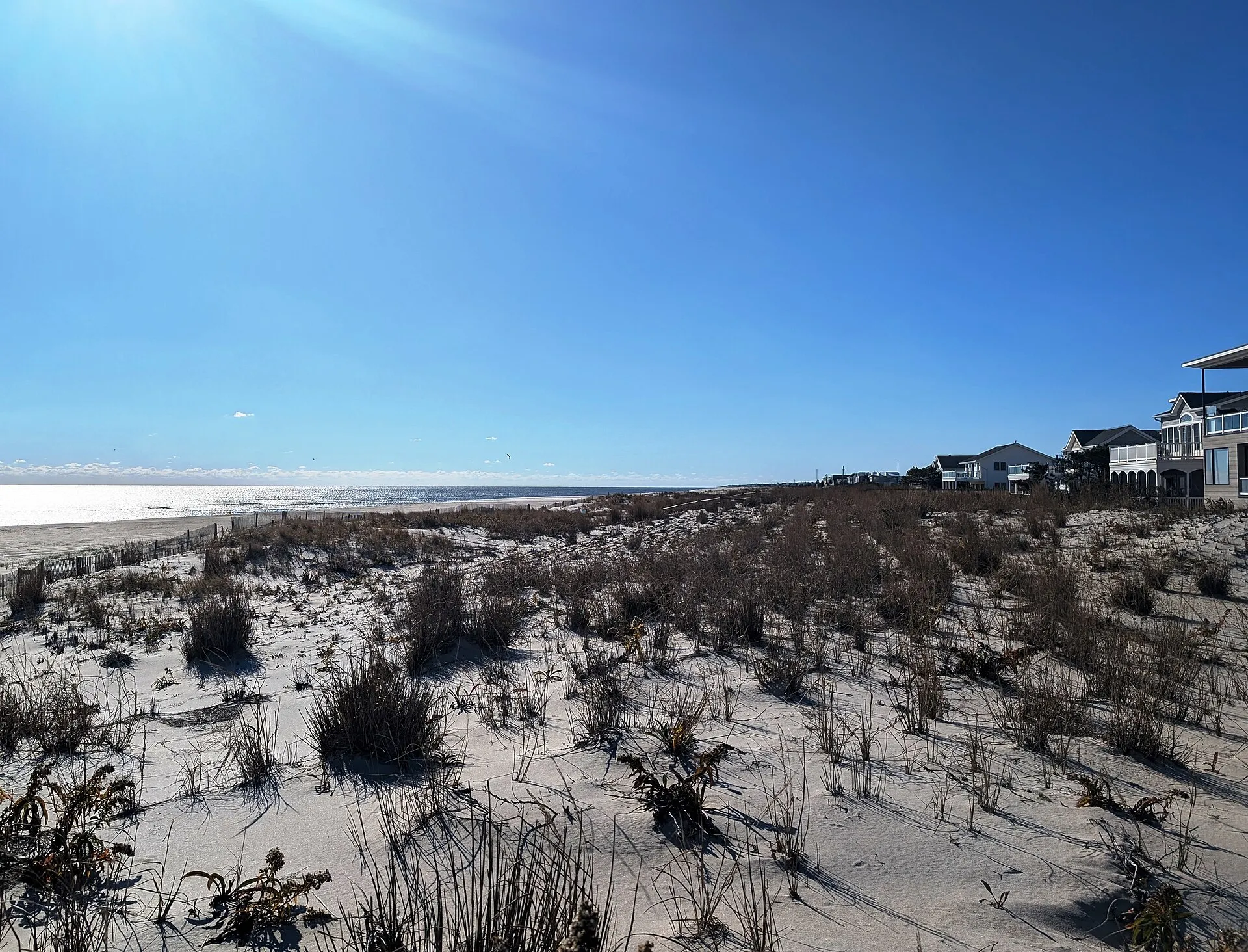 Photo of the dunes and ocean beach in Surf City, New Jersey. Photo taken from the beach entrance at Division Avenue looking south-southwest