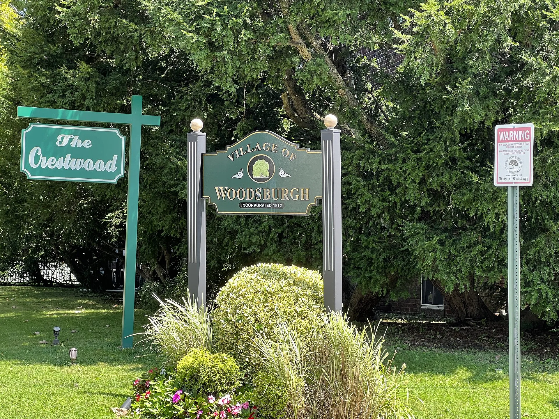 A Woodsburgh welcome sign at a village entrance, August 2022