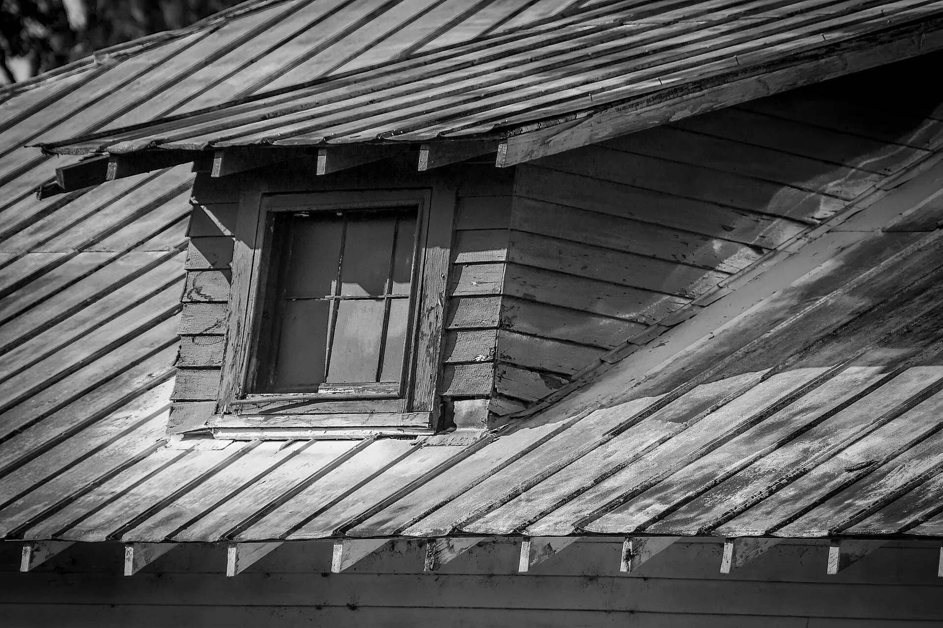 Peeling paint on an old house (black and white).