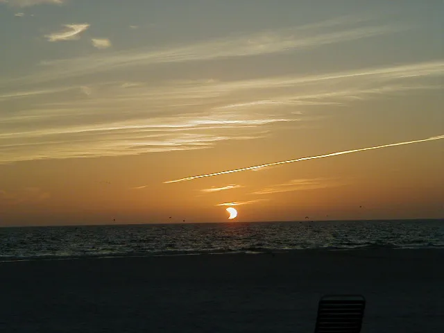 Siesta Beach at sunset during a solar eclipse.