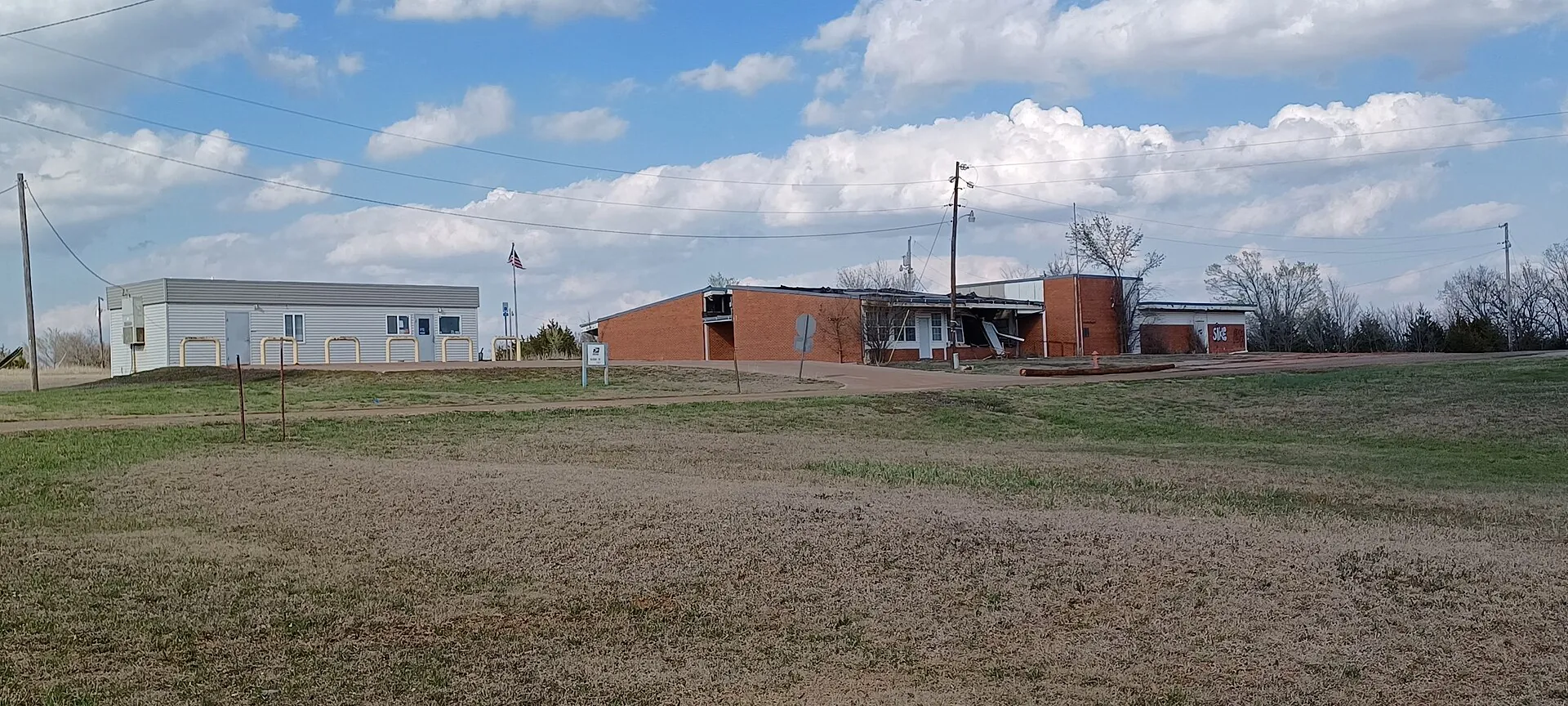 Landscape of Meridian, Oklahoma, featuring the post office and an abandoned school building.