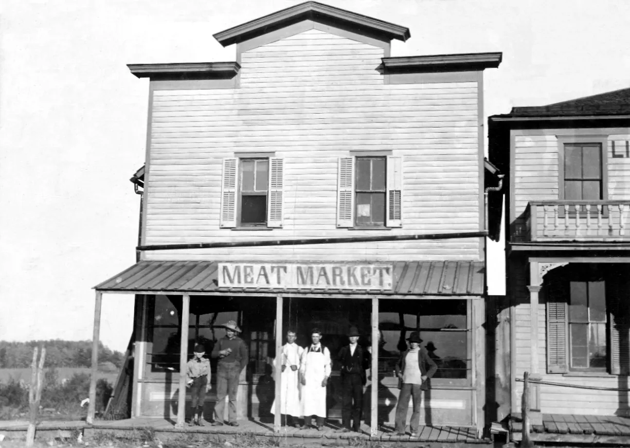 Butchers and other men standing in front of meat market. Cabinet card, Kansas Collection Photographs , University of Kansas