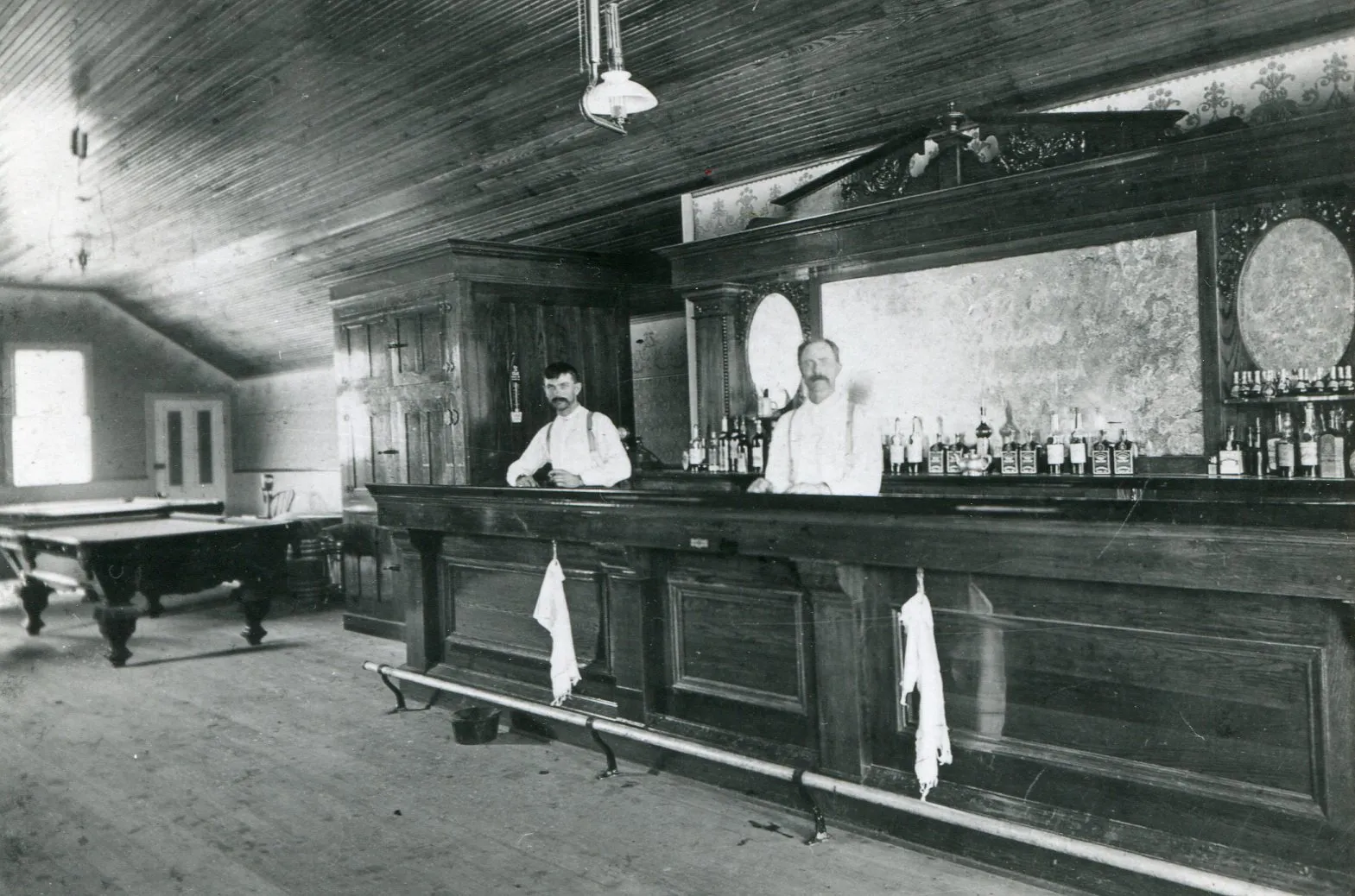 Peter F. Truhlsen & his father Niels Truhlsen behind the bar in their saloonPlace: Kennard, Nebraska