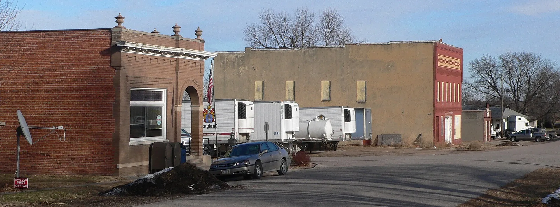 Downtown Morse Bluff, Nebraska. In the left foreground is the post office. Note the red-and-white sign "Save Our Post Office" in the lower left corner; the photo was taken at a time when the U.S. Post