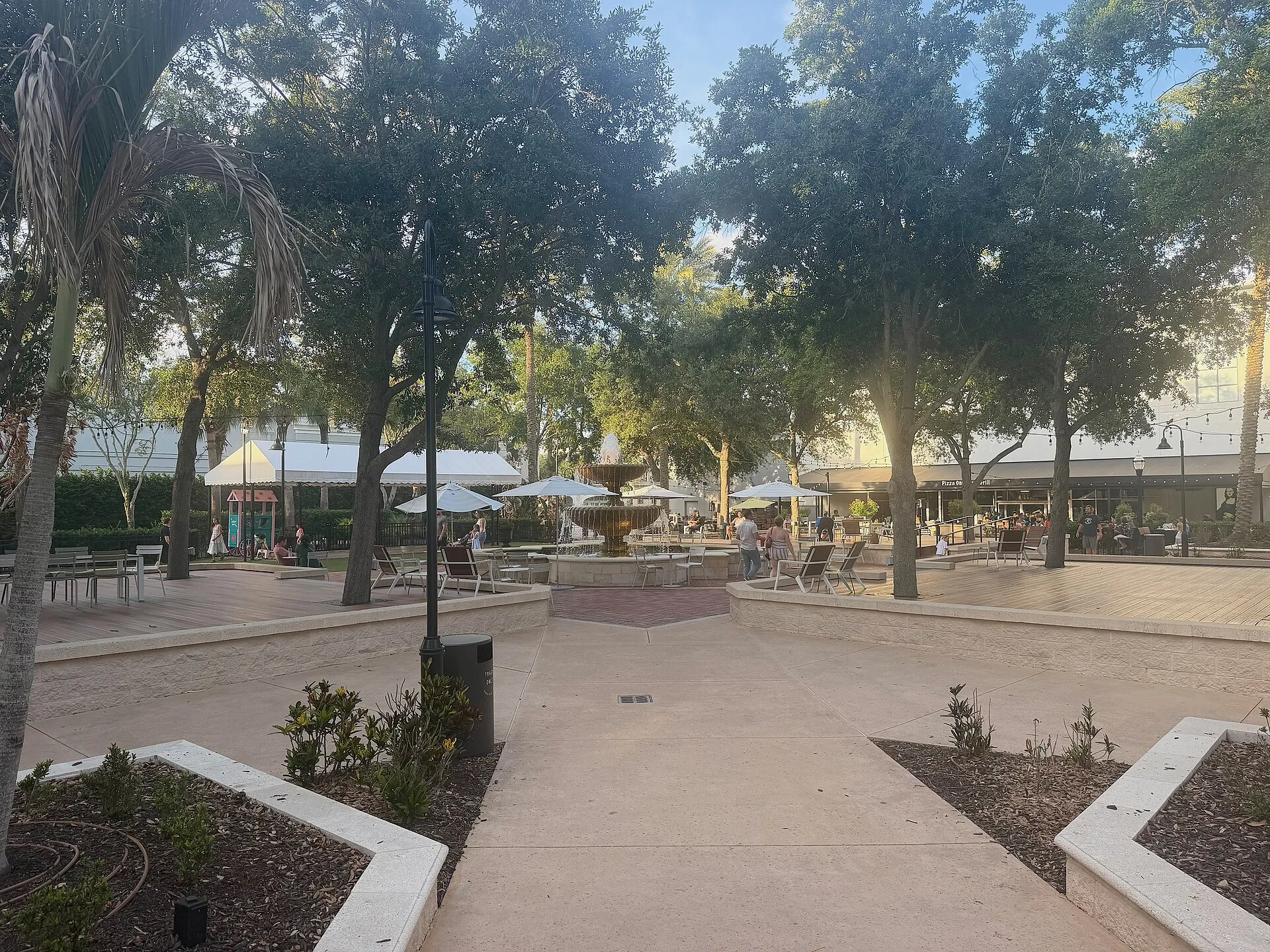 The center square of The Avenue Viera mall with courtyard restaurants and a fountain.