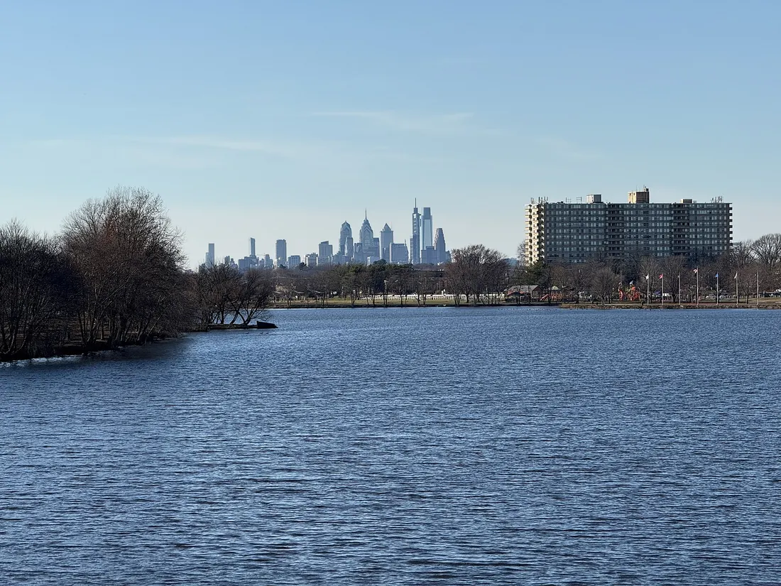 Cooper River Lake west of the County Route 636 (Cuthbert Boulevard) bridge on the border of Haddon Township and Cherry Hill in New Jersey. The skyline of Philadelphia, Pennsylvania is visible in the distance.