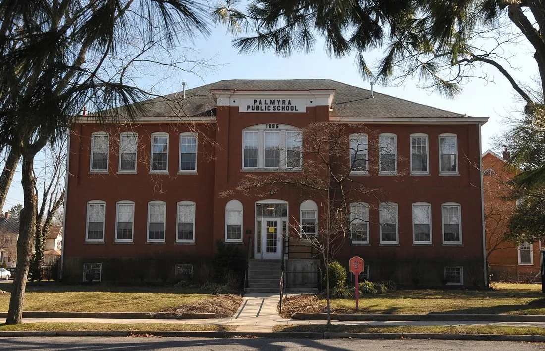 Burlington County; the building has Palmyra Public School and the date 1895 over it. The first school here was built in 1865 and was called Cinnaminson School. A second story was added in 1886. The Spring Garden Street
