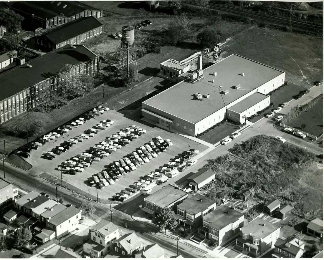 Building in the foreground is the Clifton Precision factory. Buildings to the left are part of the Kent Mills textile factory. Railroad in background is the present-day SEPTA Media-Wawa line.