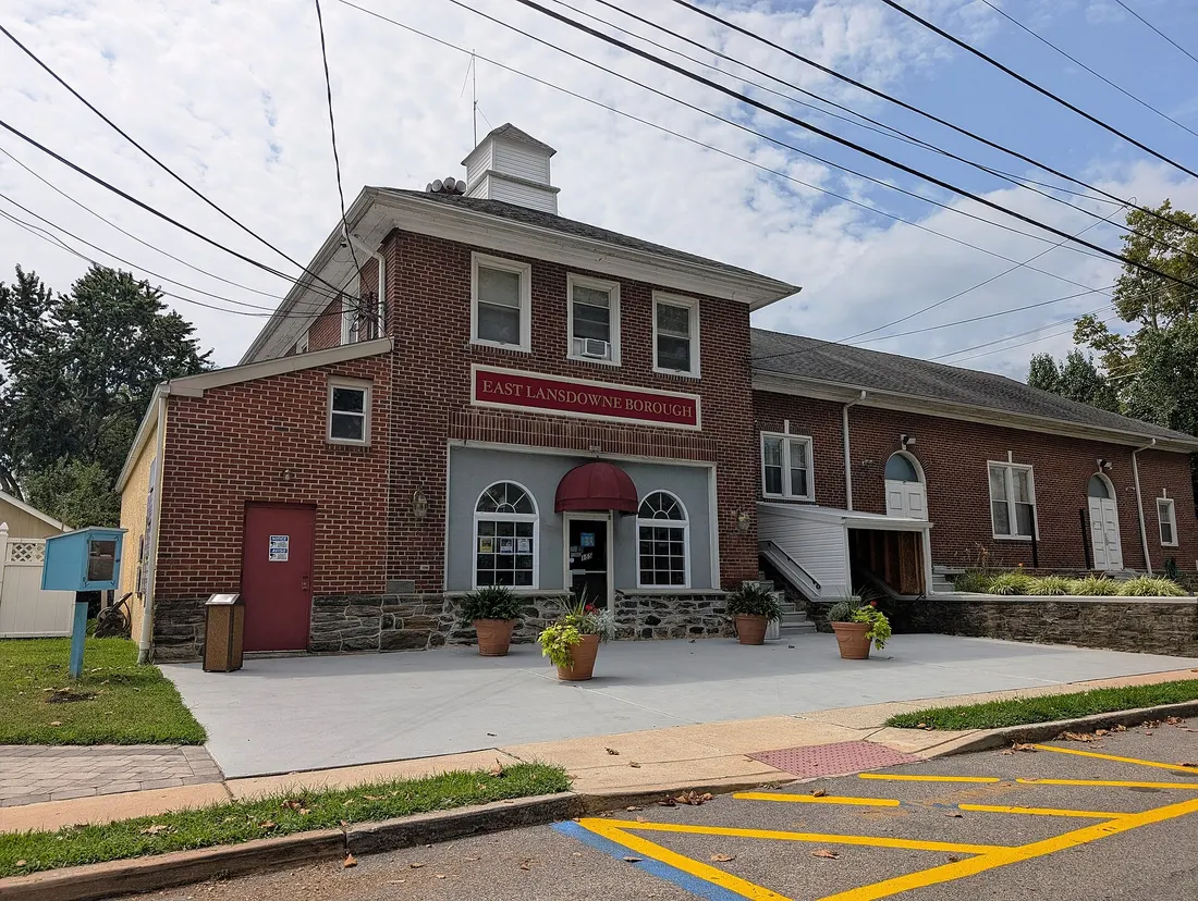 Photo of the East Lansdowne, Pennsylvania municipal building. The building appears to be a former fire station. Photo taken from Emerson Avenue looking southwest.
