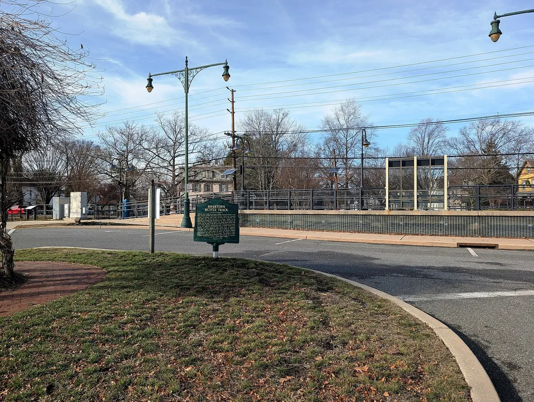 Photo of an historical marker commemorating the Riverton Bicycle Track in use from 1894 to 1896 in Riverton, New Jersey. Photo taken from South Broad Street at Lippincott Avenue looking west. Riverton station is also see