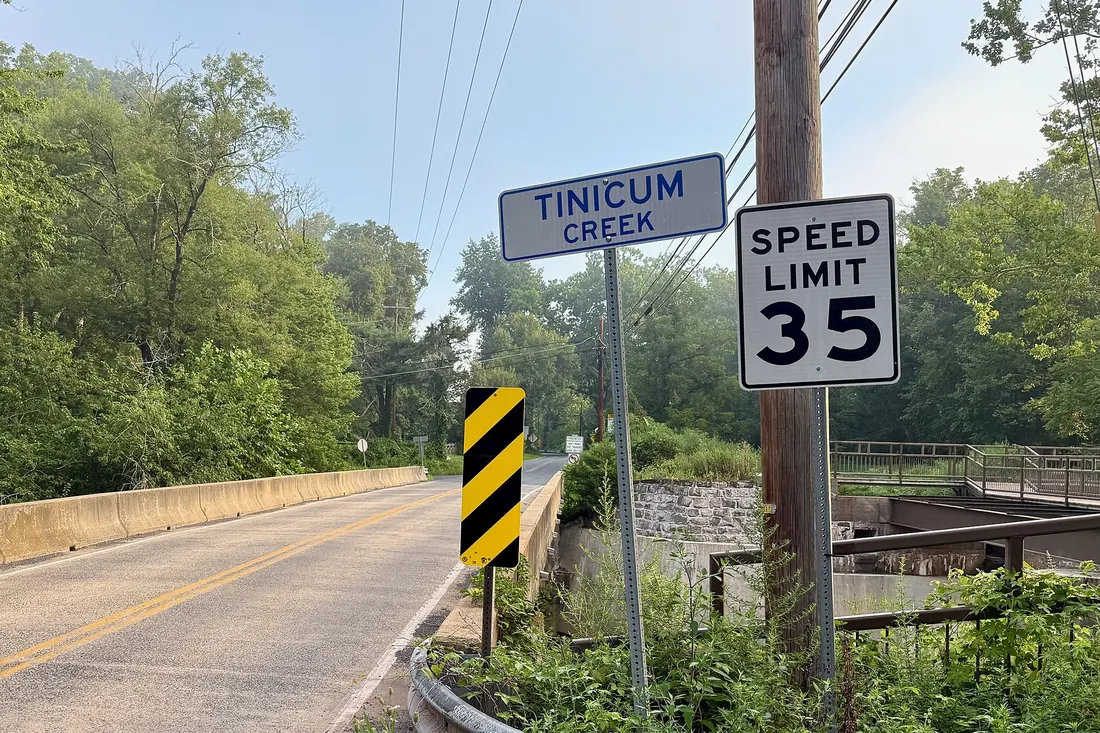 River Road (Pennsylvania Route 32) bridge over the Tinicum Creek in Tinicum Township, Bucks County, Pennsylvania. The Tinicum Creek Aqueduct on the Delaware Canal is on the right.