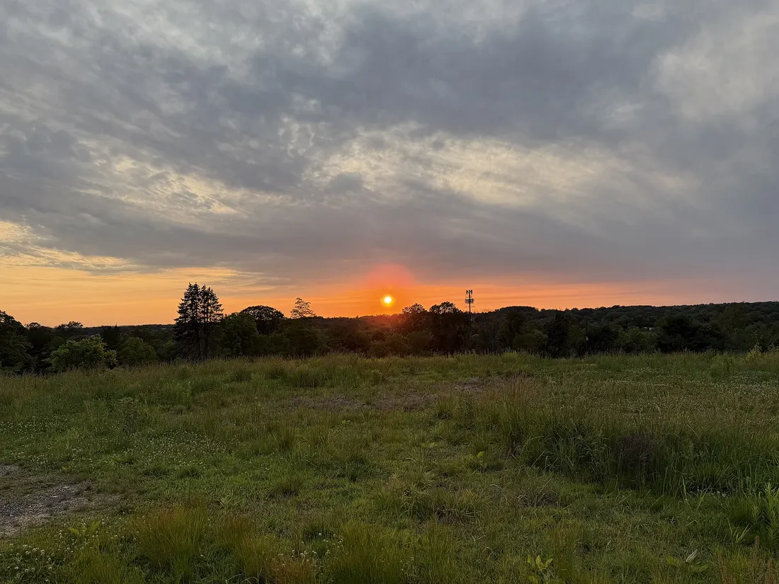 Hazy sun at sunset at Twining Valley Park in Upper Dublin Township, Pennsylvania. The haze is from wildfire smoke from Canada.
