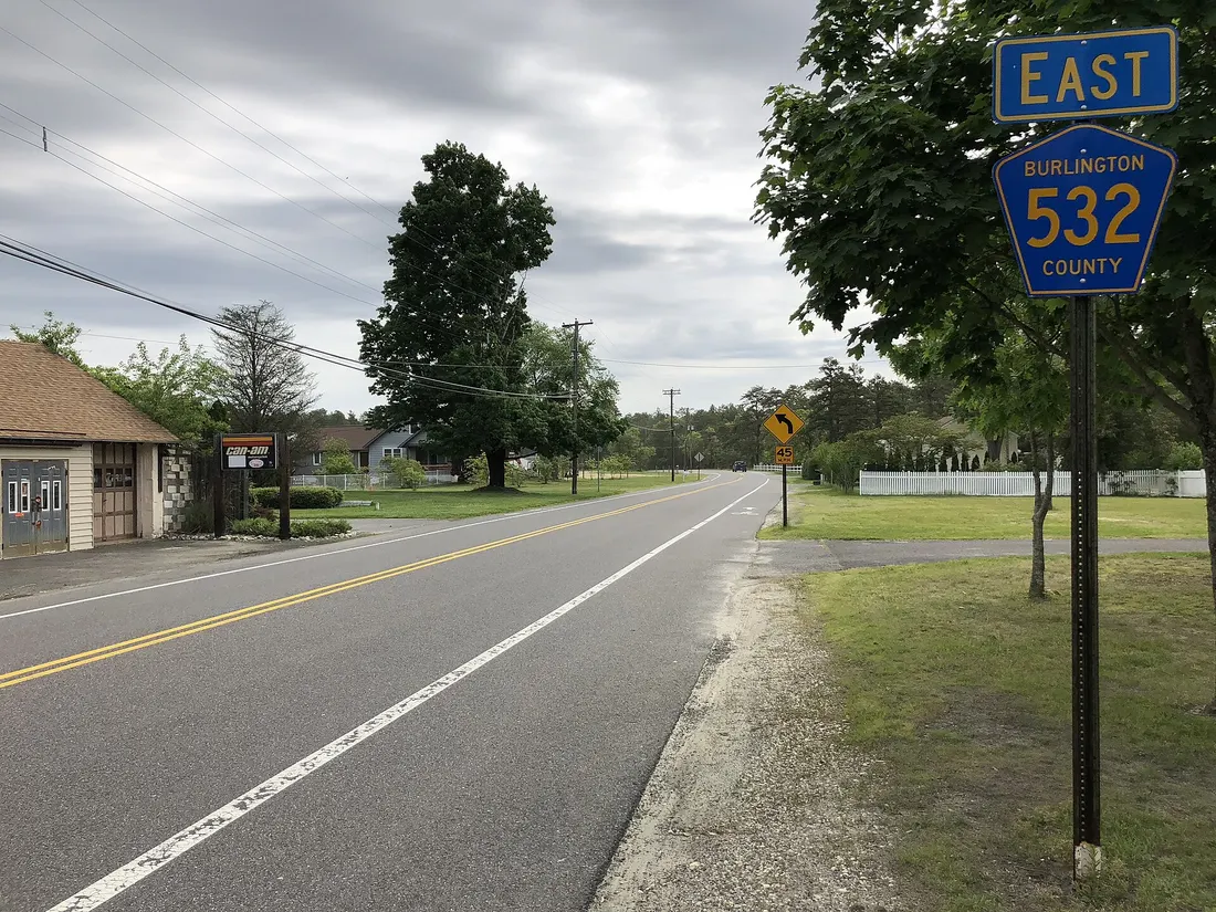 View east along Burlington County Route 532 (First Avenue) at Burlington County Route 563 (Main Street) in Woodland Township, Burlington County, New Jersey